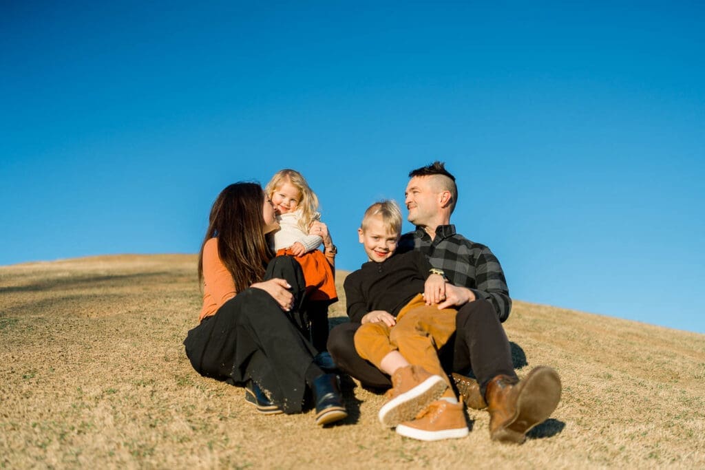 Family sitting on Cardboard Hill in Chattanooga, TN