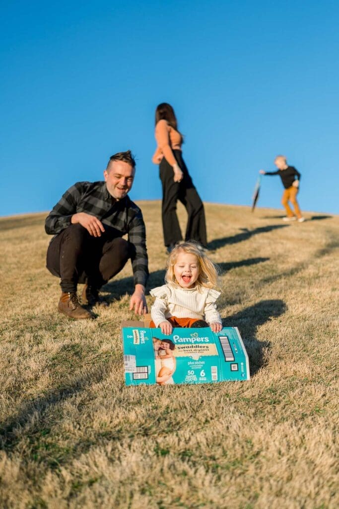 Girl sliding down Cardboard Hill in Chattanooga, TN
