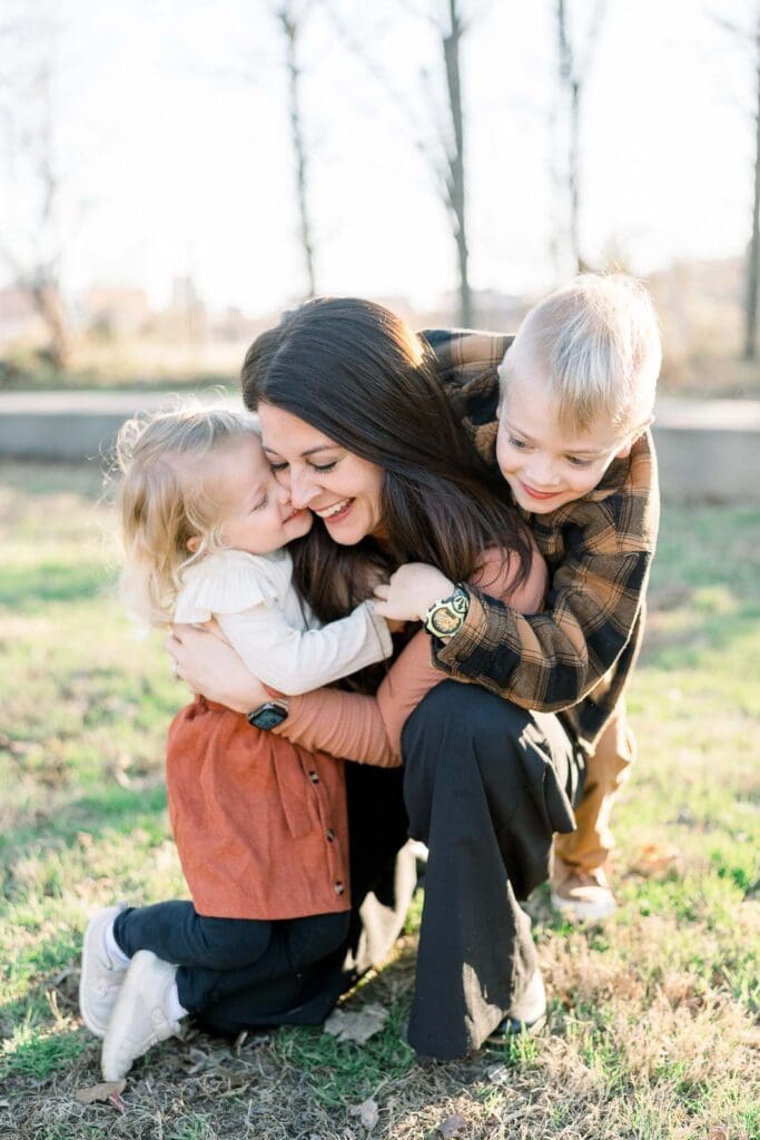 Son and daughter hugging mom