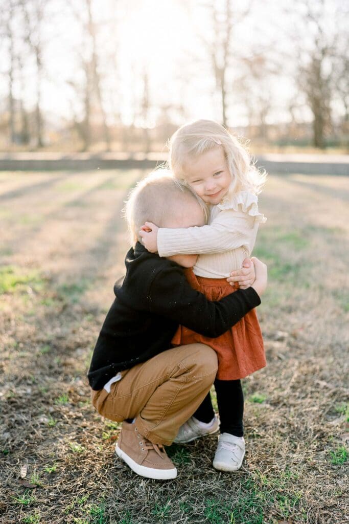 Little sister hugging brother