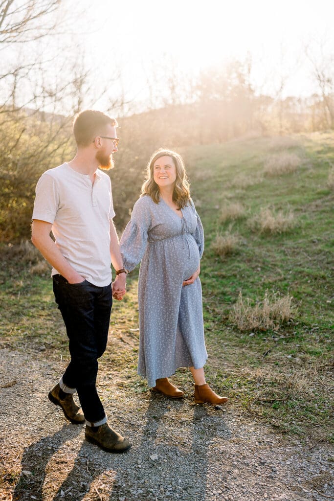 Expecting mother holding hands with spouse
