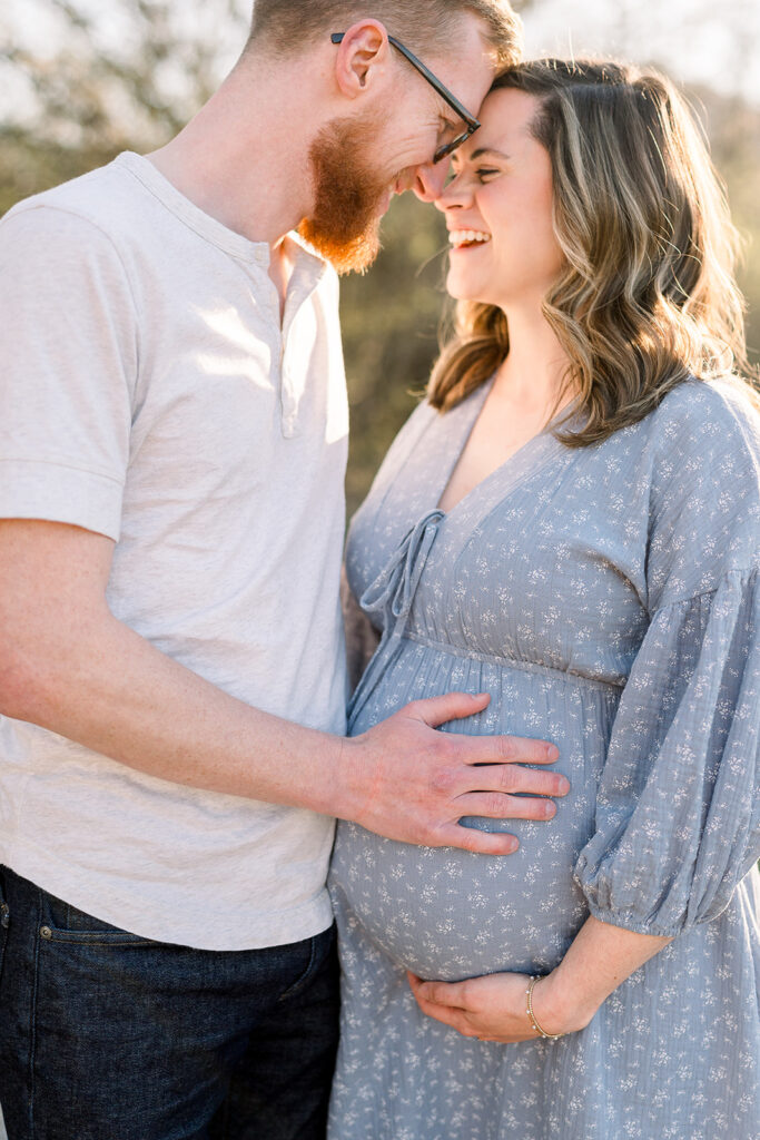 Husband touching expecting wife's belly